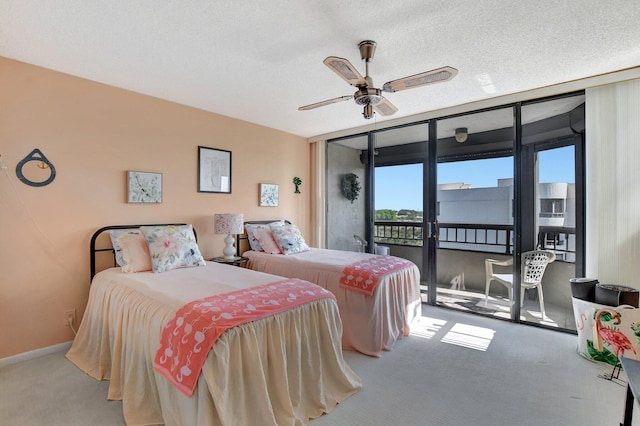 bedroom featuring carpet, access to exterior, ceiling fan, floor to ceiling windows, and a textured ceiling