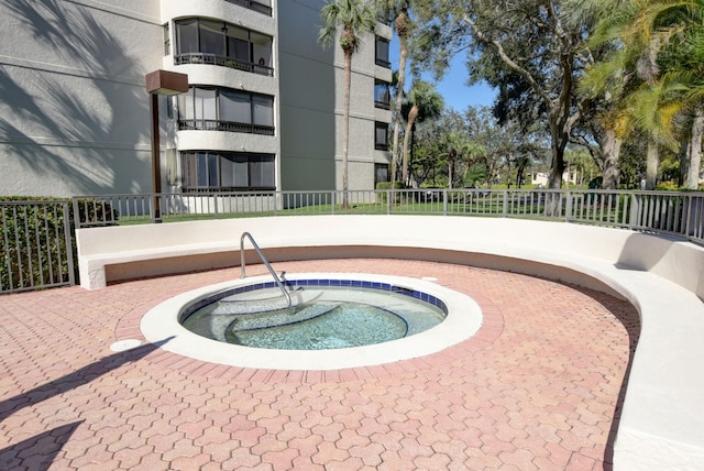 view of swimming pool with a community hot tub