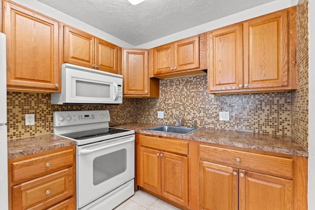 kitchen with sink, white appliances, backsplash, a textured ceiling, and light tile patterned flooring