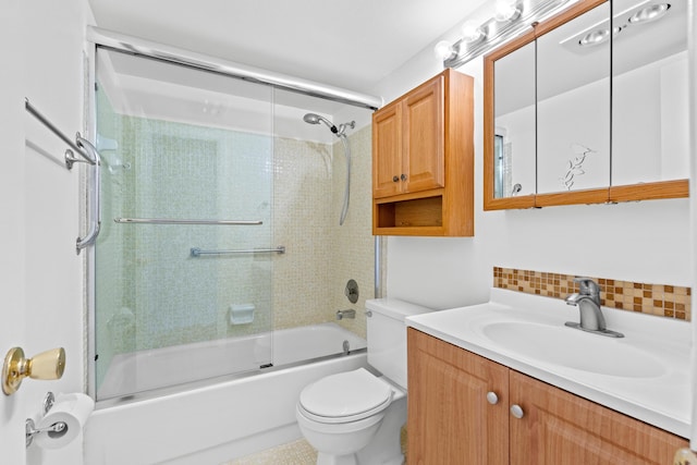 full bathroom with vanity, combined bath / shower with glass door, toilet, and decorative backsplash