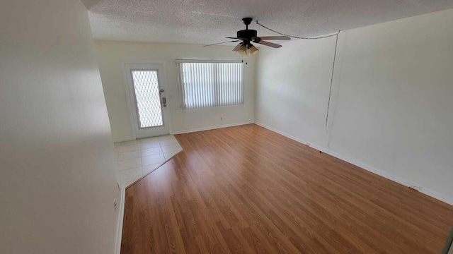 entryway featuring hardwood / wood-style flooring, ceiling fan, and a textured ceiling