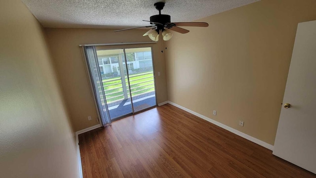 spare room with hardwood / wood-style flooring, ceiling fan, and a textured ceiling