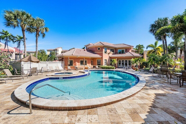 view of swimming pool with an outdoor hot tub and a patio