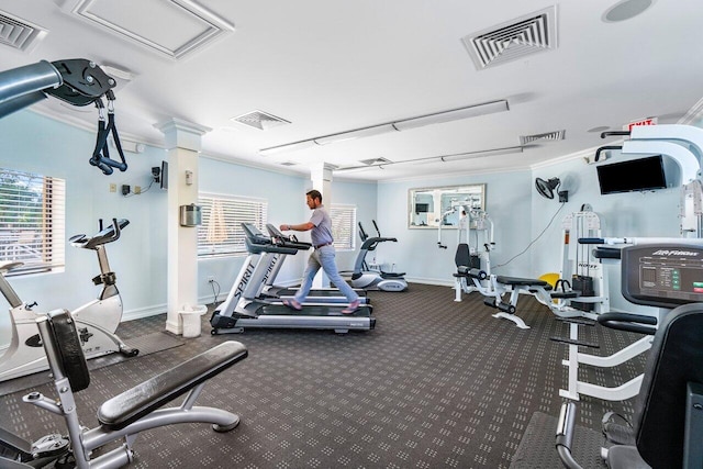 workout area with decorative columns and crown molding