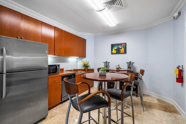 kitchen with crown molding, appliances with stainless steel finishes, and sink