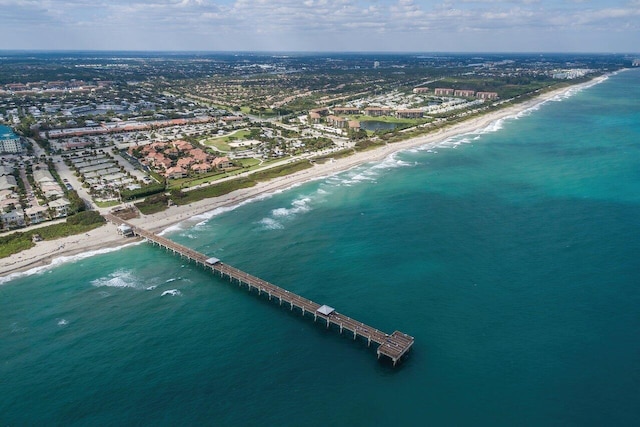 aerial view with a water view and a view of the beach