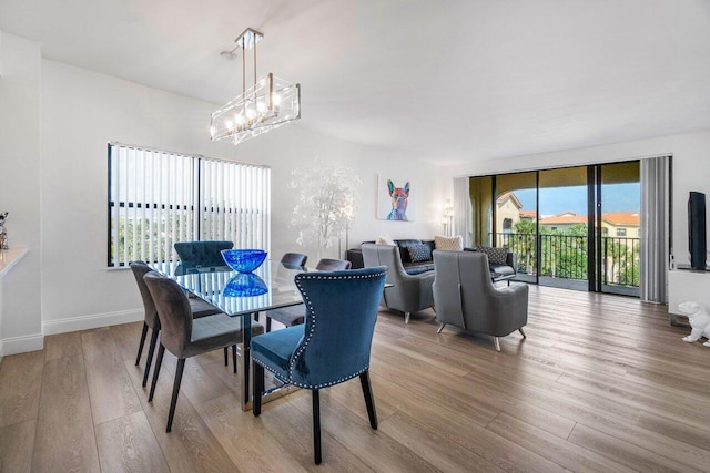 dining area featuring a chandelier and light hardwood / wood-style floors