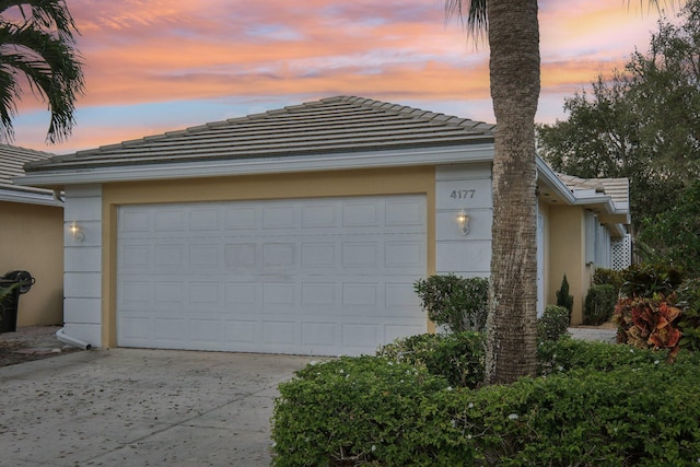 garage featuring concrete driveway
