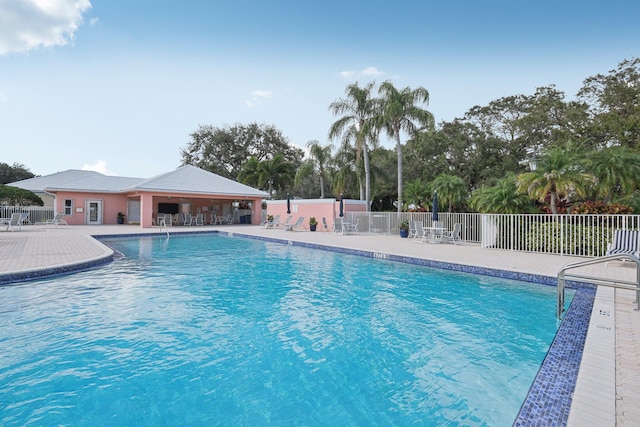 pool with fence and a patio