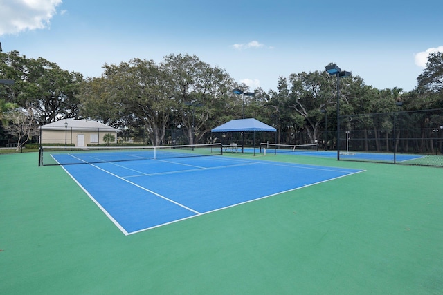 view of tennis court with fence