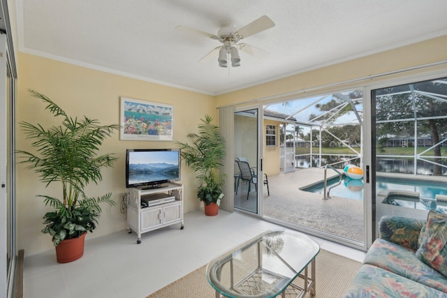living room featuring a ceiling fan, a sunroom, and crown molding