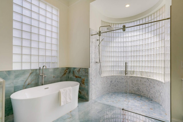 bathroom with tile walls and plus walk in shower