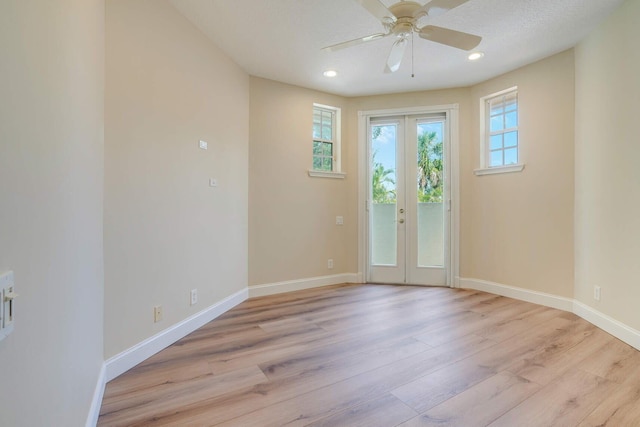 interior space with french doors, ceiling fan, and light wood-type flooring