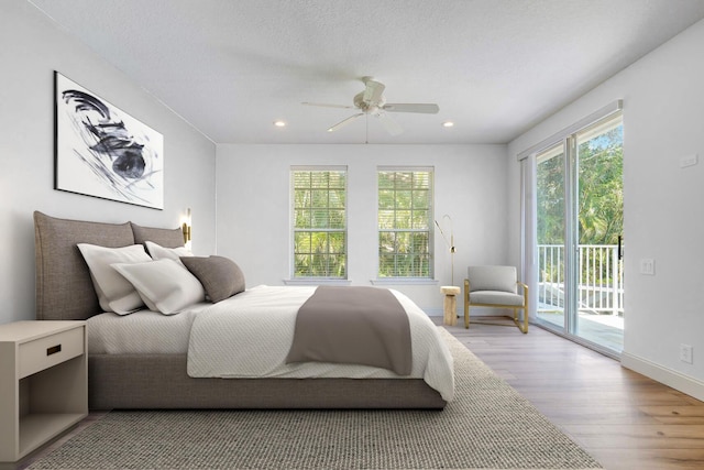 bedroom with ceiling fan, access to exterior, a textured ceiling, and light wood-type flooring