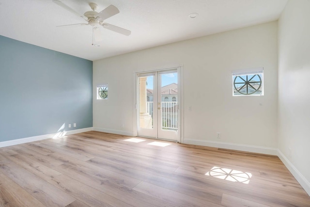 empty room featuring french doors, ceiling fan, and light hardwood / wood-style floors