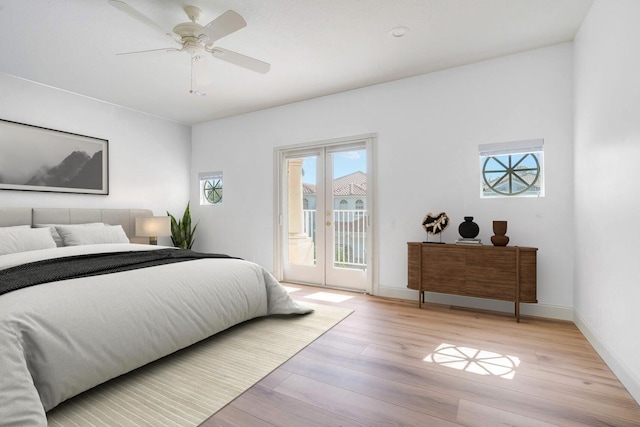 bedroom with access to exterior, light hardwood / wood-style flooring, french doors, and ceiling fan