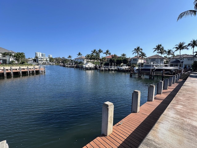 view of dock featuring a water view and a residential view