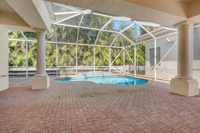 view of swimming pool featuring a lanai and a patio area