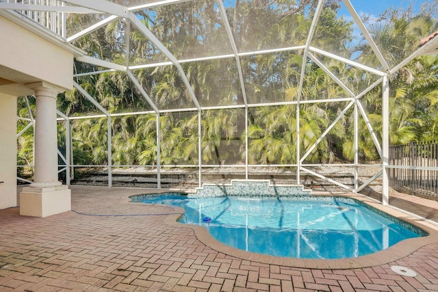 view of swimming pool featuring a lanai and a patio