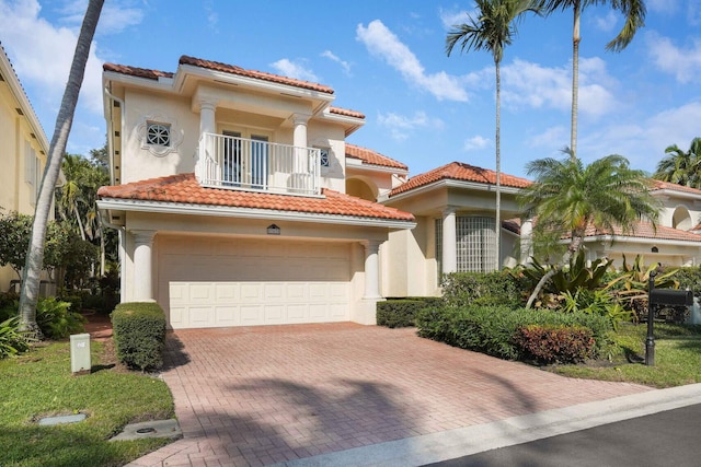 mediterranean / spanish-style house with a balcony and a garage