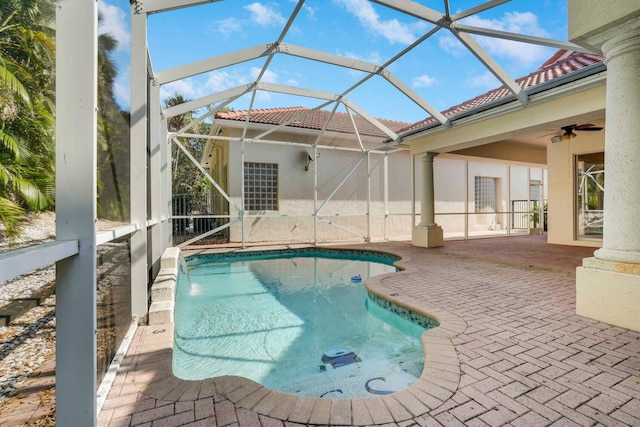 view of swimming pool featuring a lanai, a patio, and ceiling fan