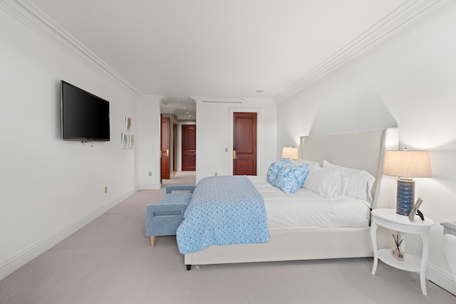 carpeted bedroom featuring baseboards and ornamental molding