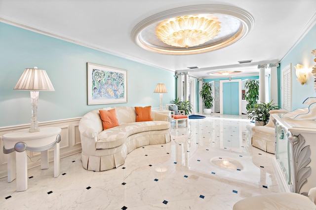 living room with ornate columns, crown molding, and a raised ceiling