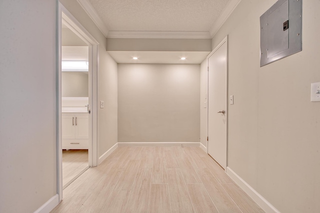 hallway with crown molding, light wood-type flooring, electric panel, and a textured ceiling