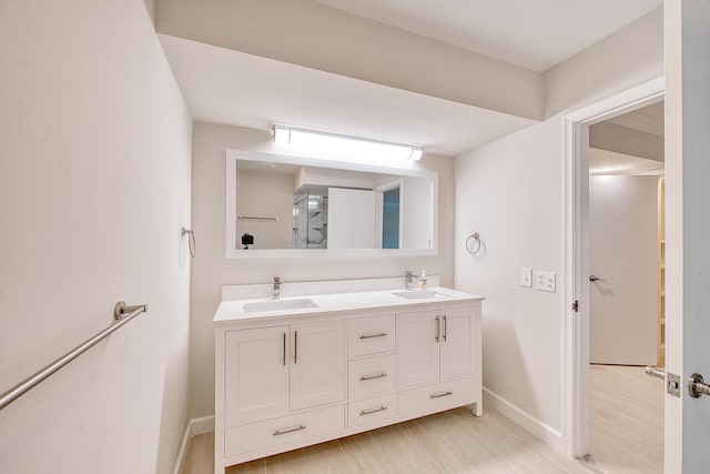 bathroom featuring hardwood / wood-style flooring and vanity