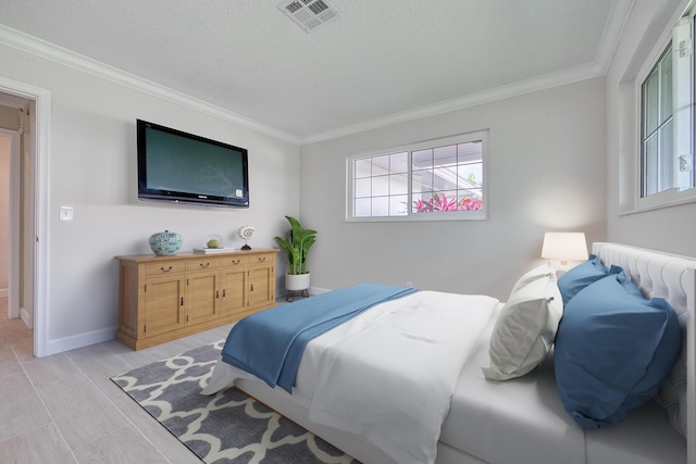 bedroom featuring crown molding and a textured ceiling