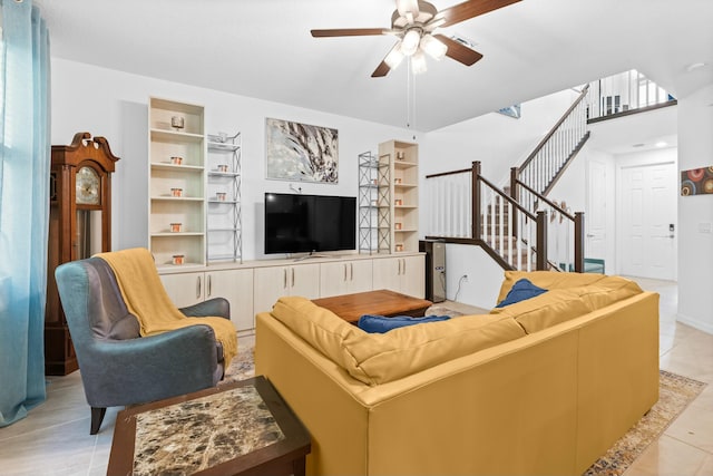 tiled living room featuring built in shelves and ceiling fan