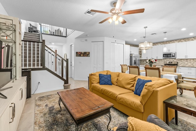 tiled living room with ceiling fan