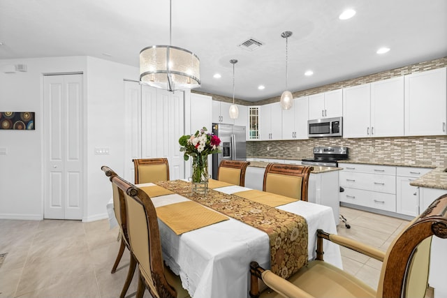 dining space featuring light tile patterned flooring