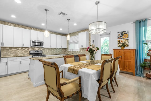 dining space featuring light tile patterned floors