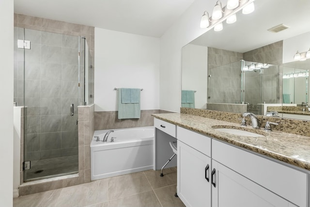 bathroom with independent shower and bath, vanity, and tile patterned flooring