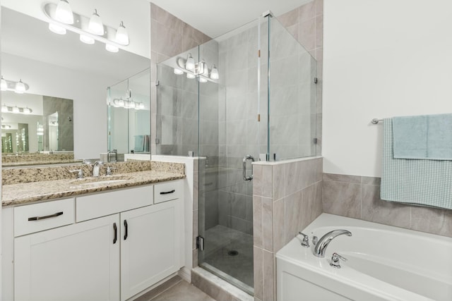 bathroom featuring vanity and shower with separate bathtub