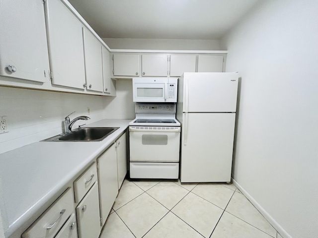 kitchen featuring white cabinetry, sink, light tile patterned floors, and white appliances