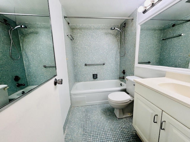 full bathroom featuring tiled shower / bath combo, vanity, tile patterned floors, and toilet