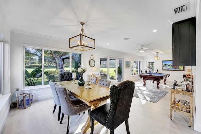 dining area featuring ornamental molding, pool table, an inviting chandelier, and light hardwood / wood-style flooring