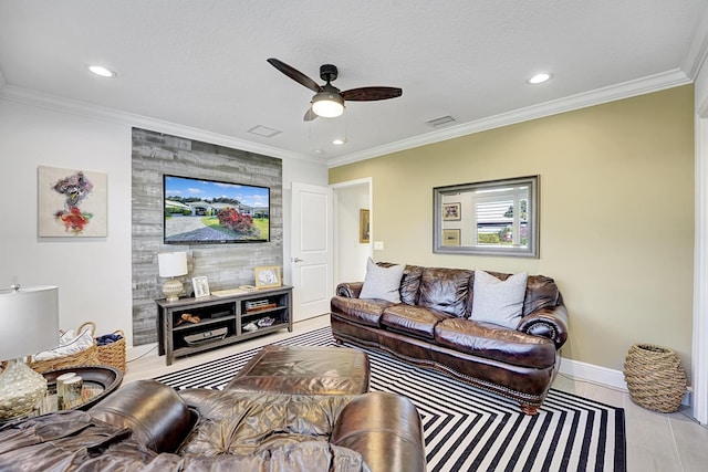 living room featuring crown molding, ceiling fan, and a textured ceiling