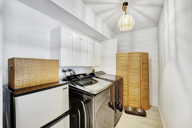 laundry area featuring cabinets and washing machine and dryer