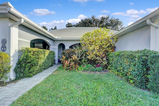 doorway to property with a yard