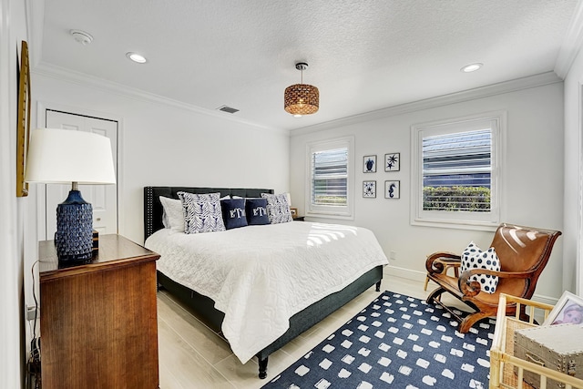 bedroom with ornamental molding, a textured ceiling, and light wood-type flooring