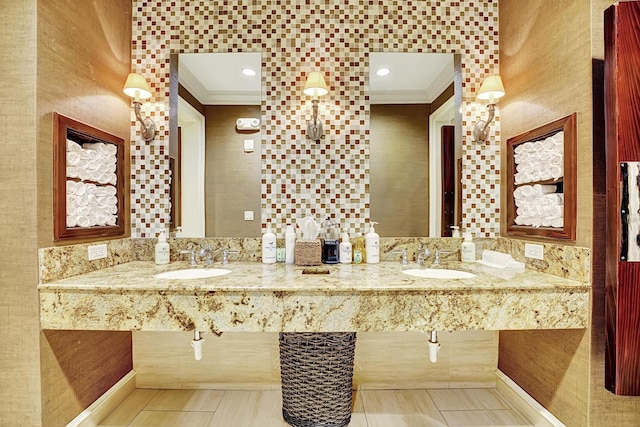 bathroom with crown molding and double sink