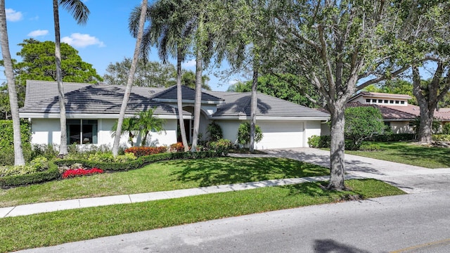 view of front of home featuring a garage and a front lawn