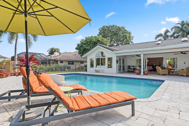 view of swimming pool featuring an outdoor living space, a patio area, and ceiling fan