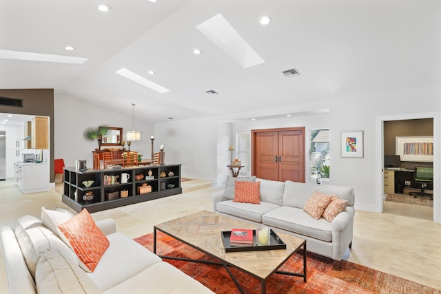 living room featuring lofted ceiling with skylight