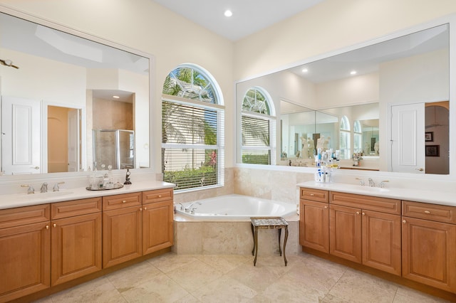 bathroom with tile patterned floors, vanity, and independent shower and bath