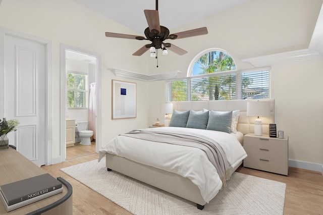 bedroom featuring ensuite bath, ceiling fan, and light wood-type flooring