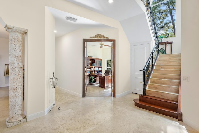 interior space with lofted ceiling and decorative columns